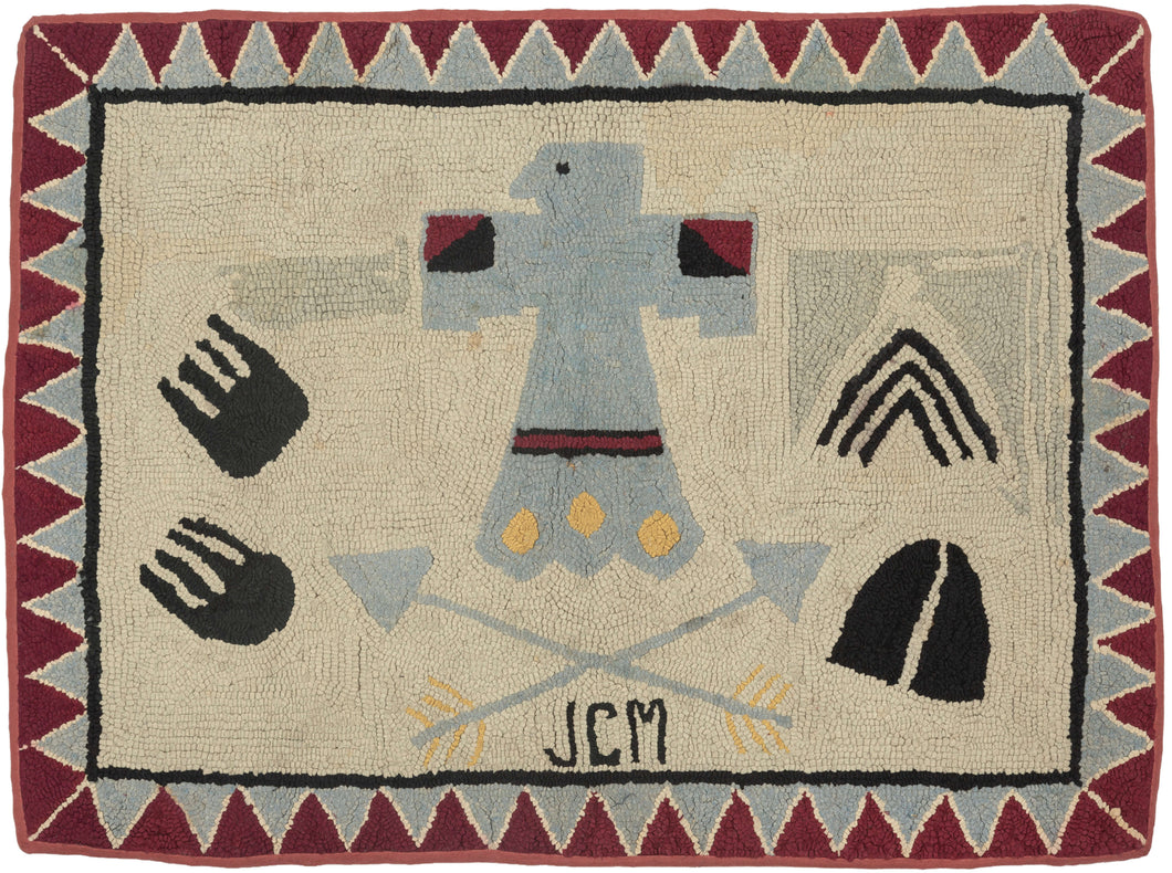 It features a variety of Native American symbols against a cream ground and framed a border of interlocking red and blue triangles that have been perfectly reconciled around the corners. The most prominent motif is a thunderbird which is a symbol of protection, power and strength. To the left are what appear to be bear paw prints (protection, power and strength) and to the right a Teepee (connection to nature and the ancestors) and a deer hoof (strength, agility and grace).