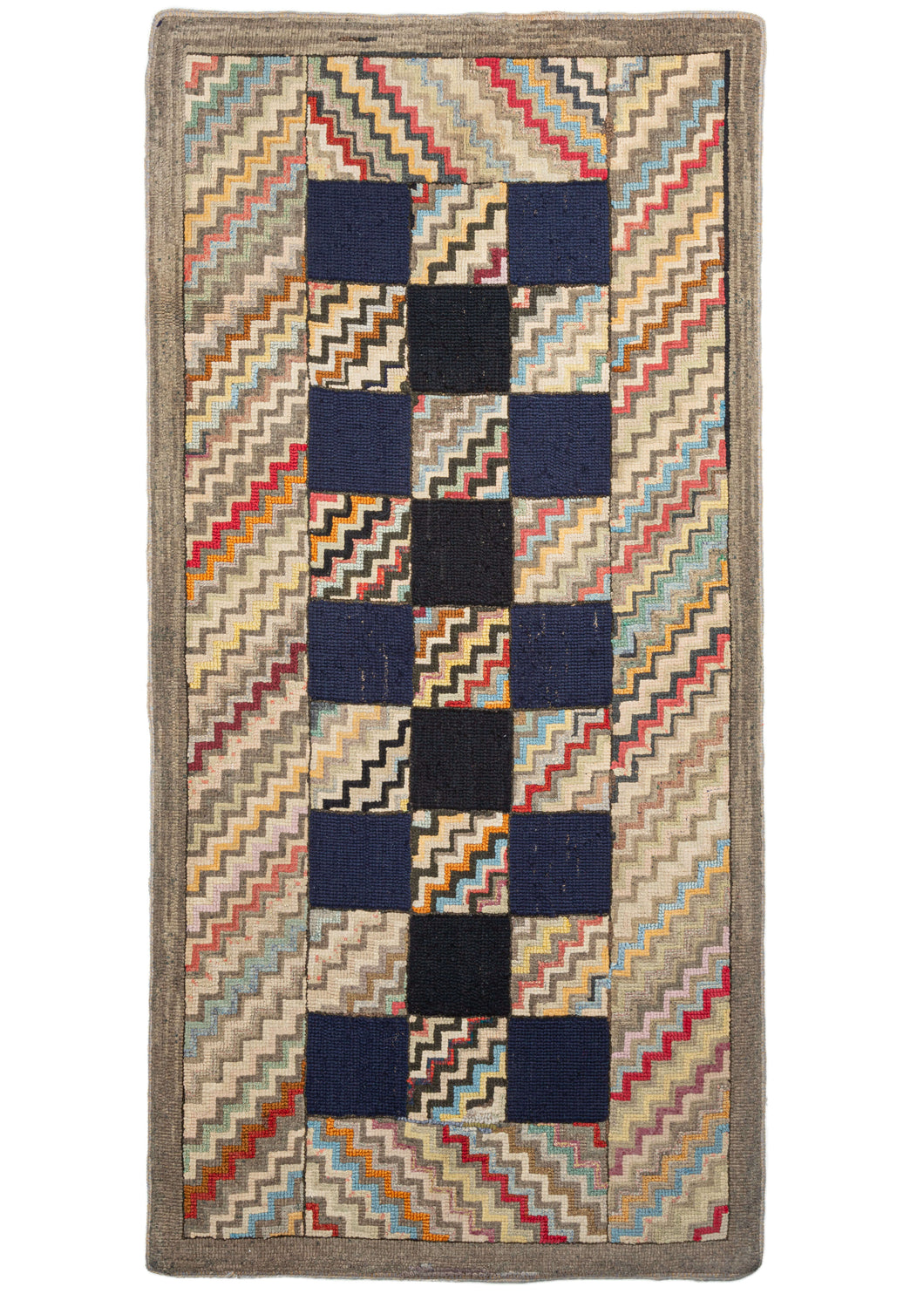 Antique North American hook rug featuring a narrow checkerboard design of blue-black squares and multicolor zig-zags. The zig-zag motif continues in the wide border, and the whole is framed by a subtle pearl gray outer border. This rug strikes the perfect balance between playful and elegant.