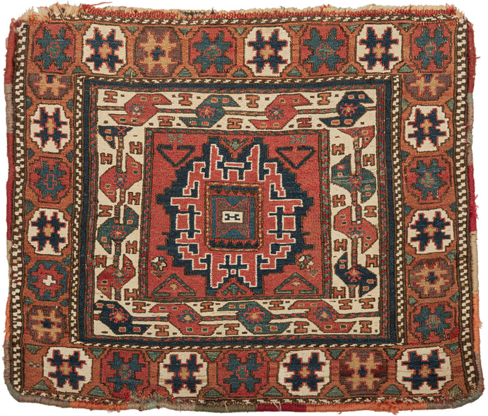 This Soumak bag was handwoven by the Shahsavan during the late 19th century.  It features a central leshgi star surrounded by an inner ivory border of serpentine sawtooth 