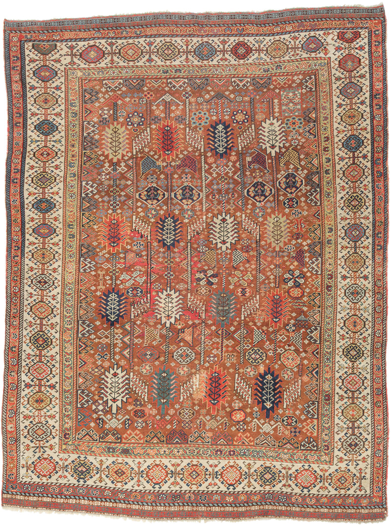 This exceptional late 19th-century Shekarlu rug is a superb example of the bold, highly expressive weaving tradition of the Qashqai Confederacy. Its rich terracotta field is animated by an elegant arrangement of towering cypress and tree-of-life motifs, interspersed with a lively assortment of tribal devices, rosettes, birds, combs, and other protective talismanic symbols that reward close inspection.