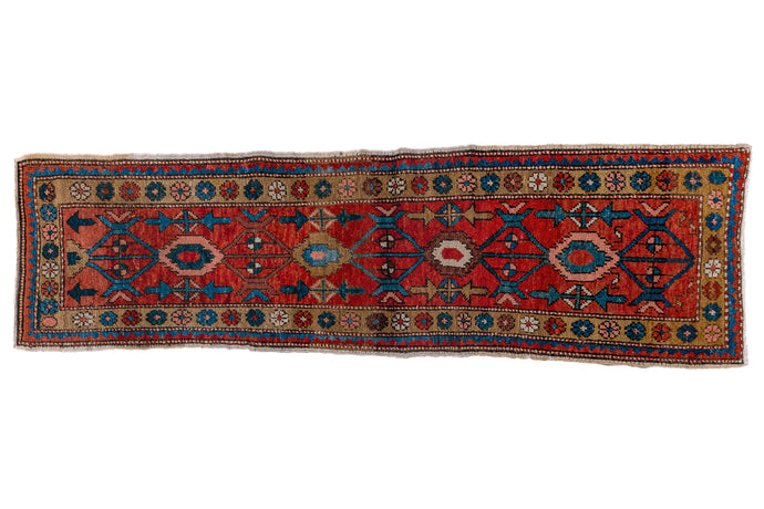 It features an simplified interpretation of the classic mina khani design on a rich red ground. Nice saturated and wonky village weaving give this rug some personality. Heriz runners are less common and this is a great narrow width and shorter length.