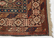 A finely woven Chi-Chi rug from the northeastern Caucasus, packed with the dense, jewel-like drawing for which the group is prized. The dark chocolate-brown field is organized in horizontal bands of stepped geometric medallions alternating with tightly worked floral and abstract devices in saturated cobalt blue, brick red, ivory, soft green, and apricot.