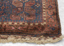 Afghan Timuri baluch It features a pattern jumbled "S" filled polygons in multiple shades of pink and purple on blue ground. Plush silky wool with a dark but lustrous complexion. Finished with kilim edges of latch hooked diamonds