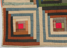 It features a variation of the classic log cabin design in 42 squares. The concentric squares are broken up by a highly contrasting concentric diamond over the top. A very striking composition with great visual power. Would be very impactful hung on a wall. Quilt