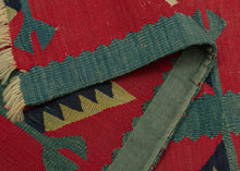 This Sarkoy kilim was in the Balkans during the 19th century.  It features a border fragment with a grape vine motif. An inner and outer border band is shown in light and dark blue. The vine is rendered in light blue with ivory grape bunches and two tone leaves of pistachio and navy on a rich red ground. Very old for type with great color and subject, would look lovely hung on a wall.