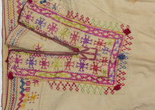 This Blouse was crafted in Afghanistan by the Hazara during the 20th century.

The Hazara are a distinct and often persecuted ethnic group that primarily live in Central Afghanistan and comprise a majority of the country's Shi'ite population. This blouse was embroidered in vibrant red, pink, purple, green and yellow silk on cotton. This embroidery style and design lexicon are classic Hazara production that can also be seen in well-known torba cloths.