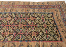 It features an allover lattice design of flowering shrubs in reds, blues, yellow, blue and aubergine on a dark brown ground. Uncommonly and to great effect a narrow red ground border of vibrant polychrome rosettes is sandwiched between two wider matching borders of simple blossoming flowers on a soft camel ground. The undulation and openness of the camel ground highlights the natural brown wool these rugs are famed for and gives the composition an open and grand feel. Serab