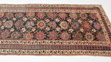 This rug was handwoven in Veramin during the early 20th century.

It features a classic mina khani design in a wide array of tones including red, pink, blue, green, purple and yellow which really pop against the deep&nbsp;surmah&nbsp;or blue/black ground. Uncharacteristically, a red and blue Laleh Abbasi pattern is utilized for the main border and flanked by ivory ground minor borders. Laleh Abbasi patterning is almost always used as a guard border around the perimeter of a rug. Other unique details include