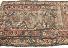 This Kurdish rug was handwoven during the late 19th century.

It features a weathered pattern of polygons filled with memling guls and surrounded by an inner border of eight pointed stars and an outer floral meander border. Wonky village weave with all natural dyes and hearty wool. The wear showcases the rugs use over more than a century and celebrates it materiality by exposing the handspun warps and wefts.