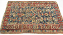 This rug was woven during the 19th century in Kuba district of the Northern Caucasus

It features an allover geometric lattice design against an indigo backdrop. A nicely spaced red ground main border provides the perfect contrast to the field. Four stylized animal figures can be seen near the bottom of the field.