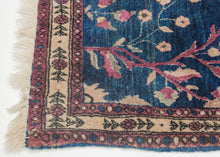 This Mohajeran Sarouk was handwoven during the first quarter of the 20th century.&nbsp;

It features an imaginative tree of life design of a small cypress flanked by two whimsically intersecting trees bearing palmette-shaped "fruit" on an inky blue ground. . Plush and well-executed these best-of-type Sarouks are referred to as "Mohajeran". Thinly framed like a painting with a generously spaced floral main border flanked by minor borders of polychrome circles;This classically patterned rug should