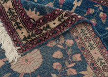 This Mohajeran Sarouk was handwoven during the first quarter of the 20th century.&nbsp;

It features an imaginative tree of life design of a small cypress flanked by two whimsically intersecting trees bearing palmette-shaped "fruit" on an inky blue ground. . Plush and well-executed these best-of-type Sarouks are referred to as "Mohajeran". Thinly framed like a painting with a generously spaced floral main border flanked by minor borders of polychrome circles;This classically patterned rug should