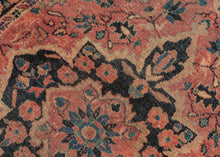 It features of an deep navy central medallion on a crimson ground. The field is filled with fine floral sprays and balanced by four scalloped cornices woven in light blue. The border is composed of a straightforward floral meander in the same deep navy almost black ground of the central medallion. SAROUK PAIR