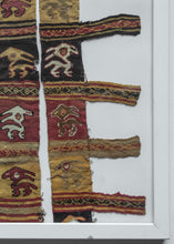 This Pre-Columbian textile fragment dates from the Chimu period.

It features two sections of a mantel with squares featuring birdlike figures in red, yellow, brown and ivory. The slit-tapestry woven squares are separated by bands of simply patterned weft float.&nbsp;