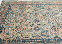 This Sarouk was handwoven during the middle of the 20th century.

The composition is composed of various weeping willows and floral bouquets in a pleasing palette of blues, reds and pinks on a pale yellow ground. This patterning is uncharacteristic of Sarouk weaving and more commonly associated with Kashan. Nicely framed by a distinctive red and yellow dual ground interlock border.