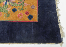 This Art&nbsp;Deco rug was handwoven in Tientsin, China during the second quarter of the 20th century.&nbsp;

This Deco rug features a central dragon surrounded by additional dragons in each of it's four corners all atop an open golden yellow ground framed by a thick unadorned navy border. The scaly and serpentine dragons come in a variety of tones and are each surrounded by colorful cloudbands which emphasize that they are in flight. In China the dragon is often depicted winglessly flying through clouds. I