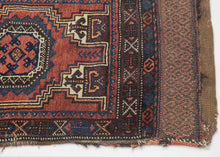 This&nbsp;Baluch rug was handwoven during the early 20th century in Afghanistan.

It features two octagonal Turkmen guls on a red ground and framed by a border of hourglass and cruciform shapes. Rich saturated tones and nice interplay between light and dark. It has original kilim ends on top and bottom that are each embellished with their own weft float pattern. This balisht has it's original kilim back still intact and which employs thick stripes of red, orange, brown and ivory.