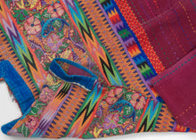 This spectacular Huipil is alive with symbolism and saturated color. The brocaded upper panel features a lush tableau of birds, flowers, and brilliantly woven fish, each motif carrying deep resonance in Maya tradition. Birds evoke freedom and the sky, flowers embody fertility and beauty, and fish symbolize life’s connection to water and abundance.

