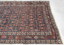 This&nbsp;Afshar&nbsp;rug was handwoven during the second quarter of the 20th century.&nbsp;

It features an all-over design that is a variation of a herati pattern. The boxy abstracted flowers are rendered in red, orange and turqouise hues on a midnight blue ground. Very figures and talismans can be found hidden amongst the field including a person on horseback and what appears to be the word "Shiraz" written in arabic script.