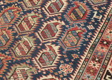 It features all over design of rows of "flaming" botehs oriented on the diagonal. The botehs are outline in glowing shades of ivory, red , turquoise and seafoam that contrast well against a navy ground. The spacing around the edge of the field is filled with various protection symbols and flora and fauna. Nicely framed by main border of interlocking "S" motifs in navy and red on an ivory ground border that brightens the composition and draws the eye to the ivory highlights in the field.&nbsp;