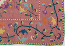 This rare small-format suzani was handcrafted in either the Nurata or Shakhrisabz region of Uzbekistan during the middle of the 19th century.

It is exquisitely embroidered in silk on a luminous cochineal dyed silk ground. The floral composition features scrolling vines and stylized palmettes in rich jewel tones. Likely made as a dowry chest cover or ceremonial cloth this suzani is backed in Russian roller print trade cloth.&nbsp;