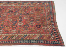 19th century It features a field of scrolling vines topped with wide blossoming botehs red, stark white, navy, indigo, and a desirable golden yellow on a red ground. It is surrounded by borders of bent ribbons, diagonal stripes and most prominently a dinosaur-like primitive bird border. This group of Afshars is thought to be woven in the Aqta region and have taken their patterning from nearby Kerman shawls. Nicely finished with striped kilim skirt borders on the top and bottom.