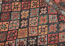 This vibrant rug showcases the bold geometry and saturated color that make these weavings among the most collectible of Kurdish works. It features the classic Jaff interlocking diamond pattern in bright, cheerful colors. The palette is exceptionally rich, with deep madder red, indigo blue, saffron yellow, ivory, and touches of soft green. Each diamond compartment has its own personality, yet the overall effect is one of harmony and movement. The star-filled borders frame the design with balance and complete