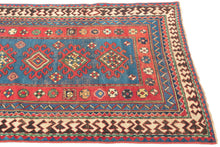 This Kazak was handwoven during the early 20th century in the southwest Caucasus.

A beautifully drawn Kazak featuring a chain of hooked diamond medallions on a vibrant sky-blue field. Each medallion is filled with either concentric diamonds or rubik's cube like grid in ivory, saffron, madder red, and deep indigo. Scattered rosettes and small geometric motifs animate the field, creating a lively rhythm. The border system is classic and powerful with an ivory “ram’s horn” outer border that encloses a richly 