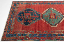 This Kazak rug was handwoven in the Southwest Caucasus during the early 20th century.

A striking example featuring three boldly drawn stepped medallions set against a vibrant, glowing red field. The palette is classic Southwest Caucasian: deep indigo, moss green, ivory, and saturated natural reds that radiate warmth and energy. The central medallion really pops and is distinguished by a lovely jewel toned blue green and enhanced by a starkly contrasting ivory outline that giving the piece strong graphic pr
