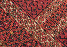 This finely woven Tekke ensi, or door rug, was woven in Southern Turkmenistan during the early 20th century. Its composition follows the traditional four-panel layout divided by a vertical and horizontal axis in a classic Hatchli format. Within each quadrant, stylized tree motifs rise in rhythmic symmetry as abstracted forms that may signify fertility, life, and renewal within the enclosed domestic world.
