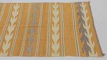This Navajo rug was handwoven during the second quarter of the 20th century.

This Navajo rug features a warm golden fields framed by crisp stepped “arrow” or chevron bands in cream and a soft, muted purple. The alternating bands create a gentle, rhythmic movement across the textile. The palette is uncommon yet harmonious showcasing the beauty of handspun wool and classic Navajo design logic.