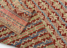 This elongated brocaded panel reflects the celebrated weaving traditions of Samugheo, the Sardinian village renowned for its mastery of pibiones “grain” weave and richly patterned household textiles. The central field displays repeated diamonds enclosing stylized stars, while the end skirts feature rare anthropomorphic figures that read either as a man and woman in union or dancers repeated in procession-like rhythm. Their presence evokes fertility, marriage, and communal celebration, suggesting the textile