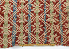 This elongated brocaded panel reflects the celebrated weaving traditions of Samugheo, the Sardinian village renowned for its mastery of pibiones “grain” weave and richly patterned household textiles. The central field displays repeated diamonds enclosing stylized stars, while the end skirts feature rare anthropomorphic figures that read either as a man and woman in union or dancers repeated in procession-like rhythm. Their presence evokes fertility, marriage, and communal celebration, suggesting the textile