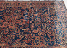 This Sarouk presents a classic, well-balanced composition centered on a bold floral medallion set against a deep indigo-blue field. The drawing is dense yet legible, with scrolling vines, palmettes, and stylized blossoms filling the field in a rhythm that feels controlled rather than crowded.