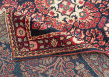 This finely woven Sarouk exemplifies the lush floral language that made the region’s carpets among the most sought-after of 1920s. Set against a deep midnight-blue ground, an intricate lattice of scrolling vines, palmettes, and rosettes unfolds with remarkable density and clarity, anchored by a subtle central medallion that gives structure to the otherwise allover composition.