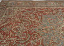 A commanding Heriz rug distinguished by a more ornate, curvilinear drawing than the classic, highly angular Heriz style. The richly saturated red field is centered by a large, radiating medallion with scrolling floral forms that lend fluidity and movement to the composition.
