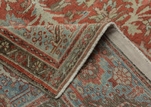 A commanding Heriz rug distinguished by a more ornate, curvilinear drawing than the classic, highly angular Heriz style. The richly saturated red field is centered by a large, radiating medallion with scrolling floral forms that lend fluidity and movement to the composition.