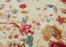 A luminous Chinese Art Deco rug with a spacious ivory field anchored by an asymmetrical flowering tree composition. Soft celadon, coral, blush, and muted gold tones float across the surface, creating an airy, painterly effect against the open ground.
