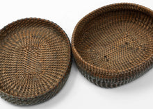 A finely made lidded basket attributed to the Kuba peoples of the Democratic Republic of the Congo, tightly plaited from plant fiber into a compact, low rounded form.

The weaving radiates outward from the center in subtly shifting directions, creating a quiet sense of movement across the otherwise unadorned surface. The closely fitted lid and shallow base reflect the technical precision for which Kuba basketry is known.