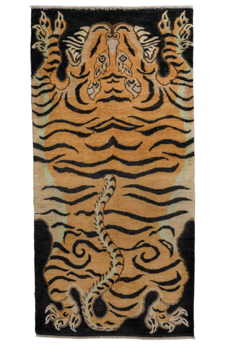 It features a tiger pelt pattern associated with Tibetan weaving culture. The ferocious looking tiger pops against the black ground and is unencumbered by borders. The tiger represents strength and determination in Tibetan Buddhism. Afghan
