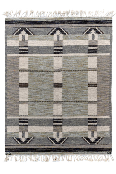 This Rollaken kilim was handwoven at Klockargårdens Hemslöjd in Sweden during the middle of the 20th century. It features a minimalistic geometric design woven with. an architectural feel. The palette of black, white, gray, olive and periwinkle is enhanced with marled yarn which softens the composition while giving it depth. Braided fringe at both ends complete the rug. Two sets of initials can be found 