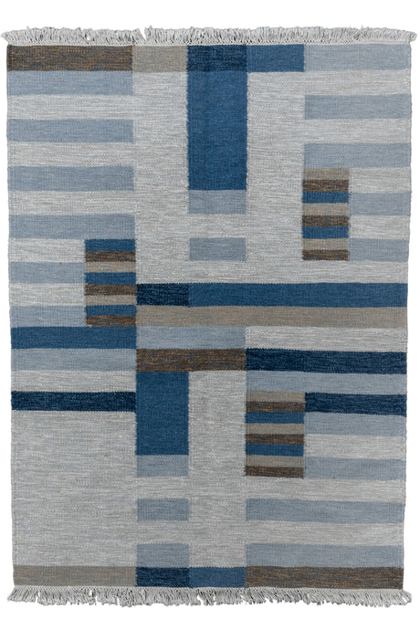 Rolakan kilim was handwoven in Sweden during the middle of the 20th century. It features a minimalist geometric design woven with a modernist feel. The straightforward palette of light and dark browns, light and dark blues, gray and white and perfectly balanced with use marled yarn.