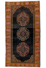 This rug features three orb-like Ay-gul or "moon" medallions atop a black ground. Four fret cornices work perfectly with the skeletal medallions. Framed by a lovely border of alternating roses.