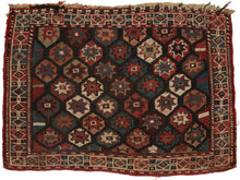 It is woven in soumak weave and features a lattice of polychrome polygons filled with eight pointed stars. The color palette red, blue, yellows, brown and green with bright whites woven in cotton. The whole is framed by a border of diamond filled cartouches.&nbsp;