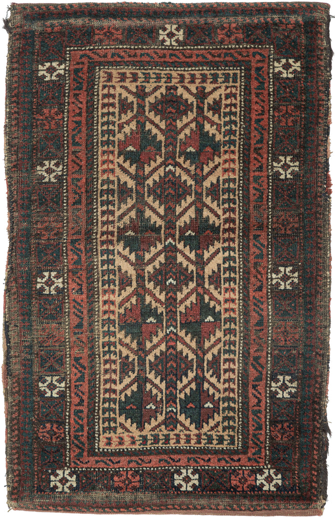 BALUCH BALISHT It features a geometric trellis motif in a variety of earthy reds and deep greens on a camel ground. The Baluch are masters of accomplishing a lot with a limited palette most often with the strategic use of white as us seen in the borders. This balisht has it's original kilim back still intact and which employs thick stripes of reds, blues, brown and purple.