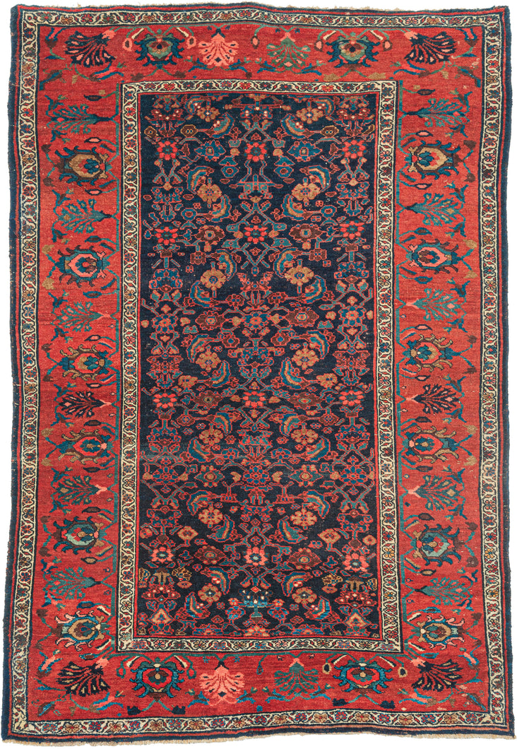  Bidjar rug was handwoven  early 20th century.  herati design of on a deep navy ground. Framed by a rich lacquer red main border that showcases beautifully spaced detailed palmettes. Flanked by floral meander minor borders that add some brightness. The lacquer red main border accentuates the red rosettes in the herati field and the lighter blue tones sparkle against the deep navy ground. With a low, dense pile