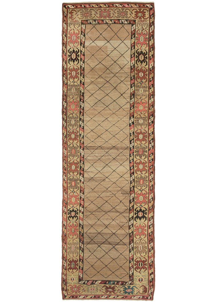 This Camel Hair Bidjar Runner features a simple yet stunning thin diamond lattice on a camel ground. The lattice pattern utilized a brown that has oxidized giving the rug an unintended but wonderful dimensionality as if it was etched in. The ground is woven of various lots of undyed camel wool fields which undulates organically and is quite calming. The main border features pelt-like devices in various browns, reds, green,s and blue flanked by diagonal striped minor borders filled with an 