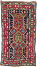 This rug was woven in the Karabagh region of the South Caucasus during the late 19th century.   Itt features a powerful all design of angular shapes on a deep navy ground. Framed by a main border of geometric plus shaped rosettes sandwiched between two "s" minor borders.