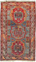 This Kazak rug was handwoven in the southern Caucasus during the second quarter of the 20th Century.  It features three medallions in reds, gold, Ivory, and green on a wonderfully abrashed purply-blue slate ground with a variety of neatly organized protection symbols. The main border is composed of alternating pairs of dragon-like "S" forms and flanked by simplified minor borders of single "S" forms. A well-balanced Caucasian weaving in a hard-to-find large format.