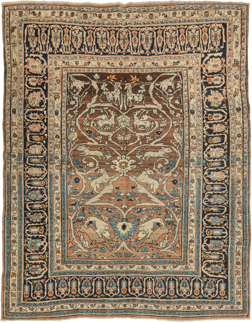 This Hadji Jalili Hunting Tabriz features a classic hunting motif against a backdrop of scrolling arabesques on a desirable burnt orange ground that is highly characteristic of Hadji Jalili weaving. The arabesque grows from central palmettes sprouting leaves and floral forms while providing a lush landscape for various animals to frolic. The animals are rendered in pairs with the most prominent showcasing lions hunting deer near the bottom.